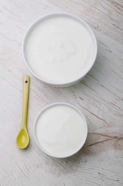 Две тарелки с молочным продуктом и ложкой — стоковое фото