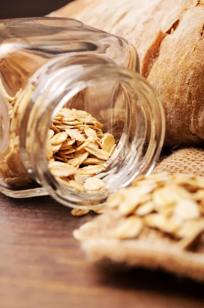 Oats in a tiny jar on side — Stock Photo, Image