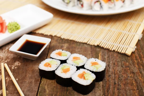 A set of salmon sushi on a wooden table — Stock Photo, Image