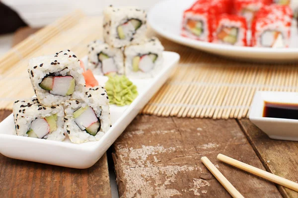 A set of sushi on a plate and chopsticks — Stock Photo, Image