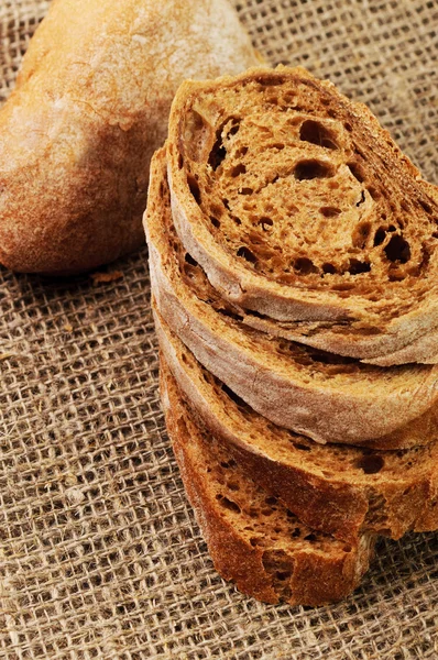 Dried italian baguette on a linen surface — Stock Photo, Image