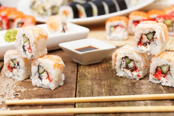 Several sushi with chopsticks on the table — Stock Photo, Image