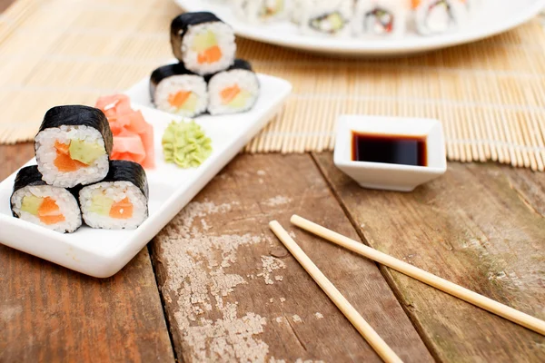 A set of sushi on a rough wooden table — Stock Photo, Image