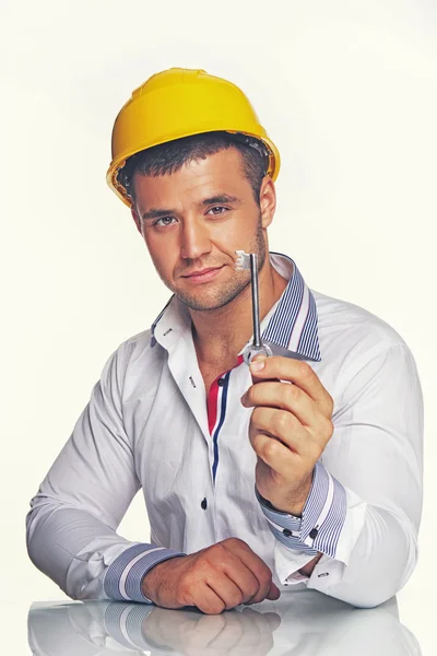 Engineer with metal key — Stock Photo, Image