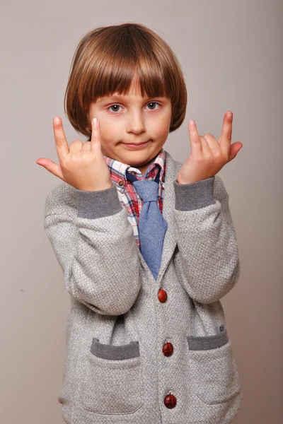 Boy shows heavy metal gesture — Stock Photo, Image