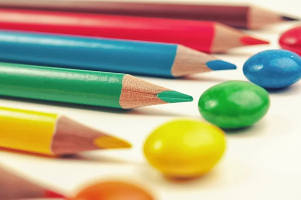 Candies and pencils — Stock Photo, Image