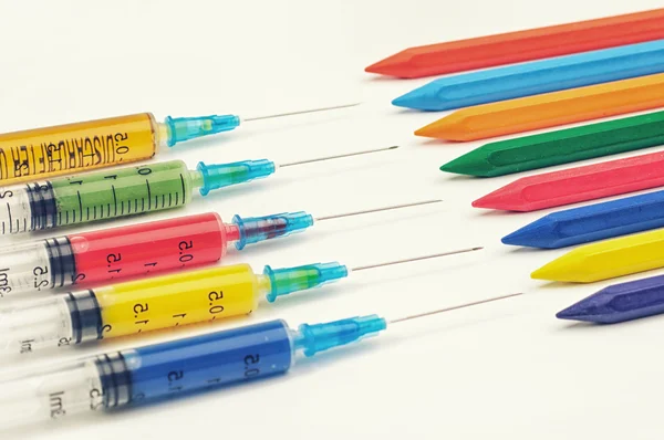 Colorful syringes with crayons — Stock Photo, Image