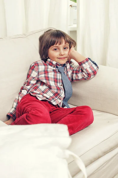 Pojke på vit soffa — Stockfoto
