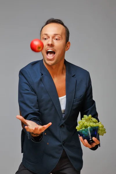 Man with apple and grape — Stock Photo, Image