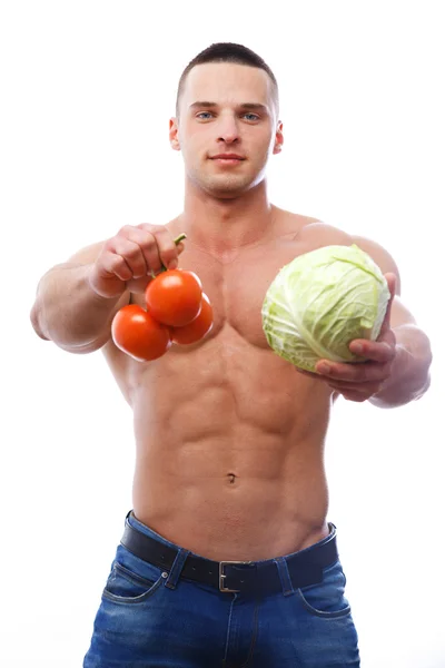 Topless guy holding tomatoes and a cabbage — Stock Photo, Image