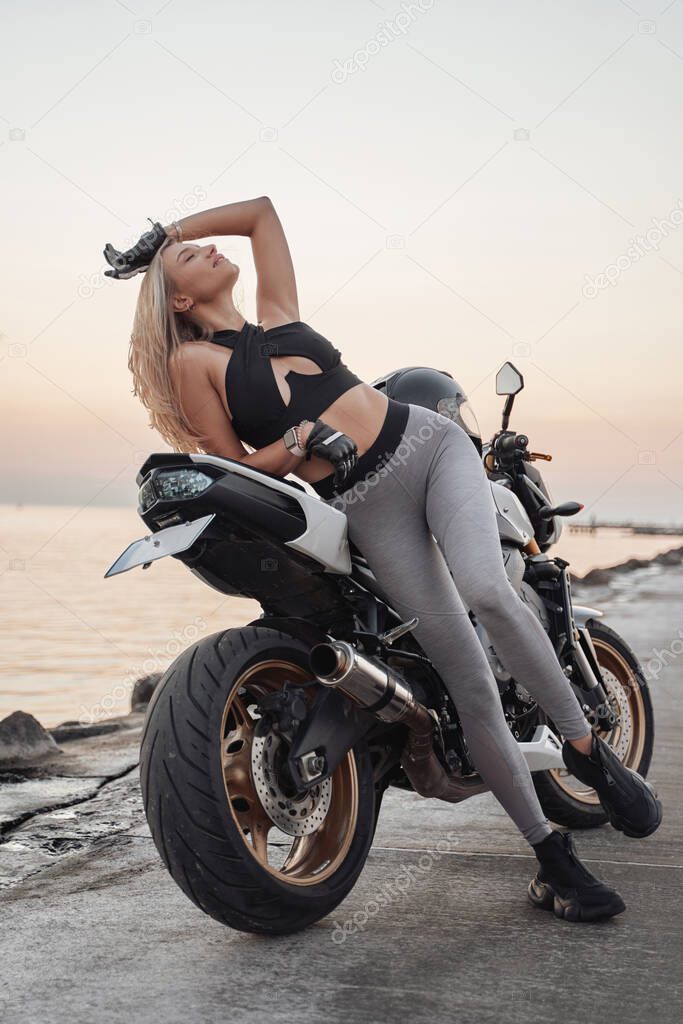 Blond haired woman enjoying her trip against sunset