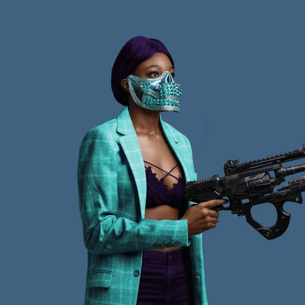 Black woman with gun dressed in trendy colorful clothing — Stock Fotó