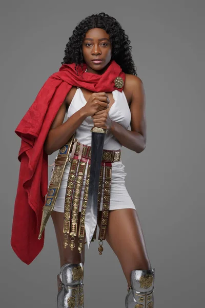 Military black woman with gladius and red cape — Stock Photo, Image