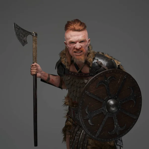 Mad redhead viking with shield and axe isolated on gray — Stock Photo, Image