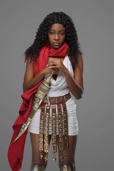 Stylish black woman with long wavy hairs and sword — Stock Photo, Image