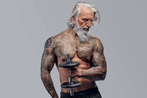 Brutal old man bodybuilder with dumbell isolated on white — Stock Photo, Image
