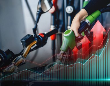 Fiyatlarda artış. Benzin istasyonunda motoruna yakıt dolduran kadın.