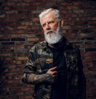 Dövmeli, kamuflaj ceketli şık bir büyükbaba.