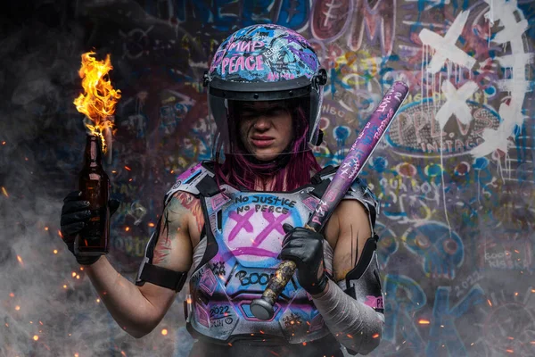 Tattooed woman activist with molotov holding baseball bat — Stock Photo, Image