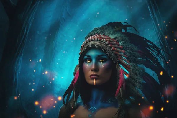 Mystical woman with feather headdress against blue forest — Stock Photo, Image