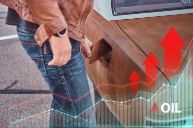 İnsanoğlunun eski otomobilinin yakıt deposunu açtığı yakın çekim.