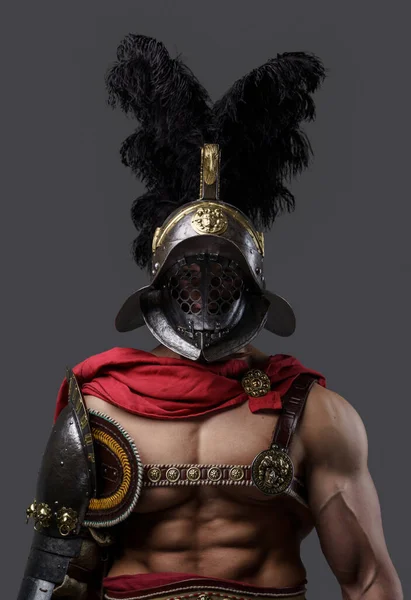 Naked colosseum warrior dressed in light armor and plumed helmet — стоковое фото