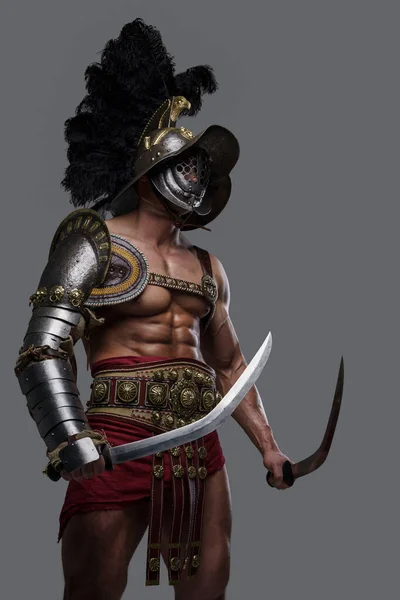 Shirtless colosseum warrior with twin swords against grey background — Stock Photo, Image