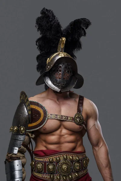 Naked colosseum warrior with helmet isolated on gray background — стоковое фото