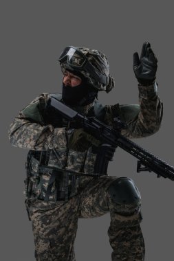 Combative army man with firearm rifle commanding assault