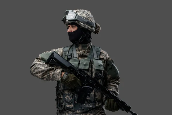 Brave army man with firearm rifle looking away — Stock Photo, Image