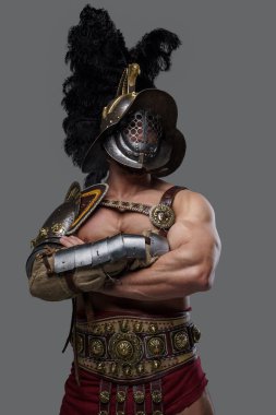Confident colosseum warrior with helmet isolated on gray background