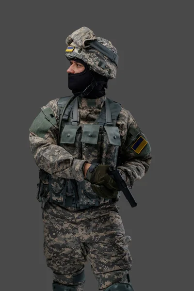 Ukrainian army man with firearm pistol looking away — Stockfoto