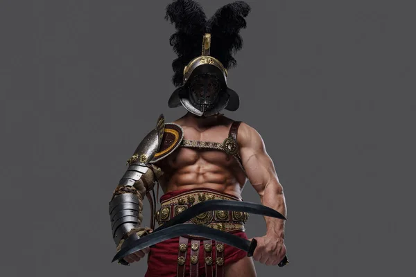 Combatieve gladiator met dubbele zwaarden tegen grijze achtergrond — Stockfoto
