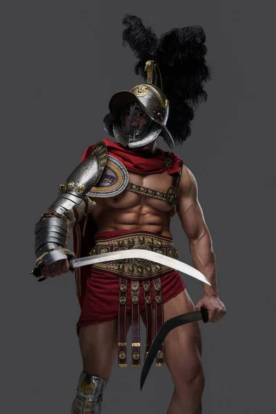 Violent roman gladiator with helmet and twin swords — Stock Photo, Image