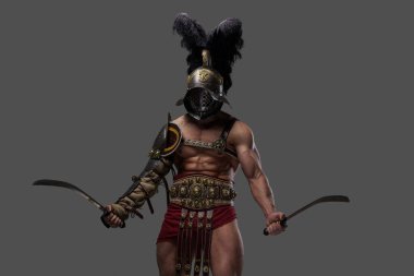 Aggressive roman gladiator with naked torso dual wielding swords
