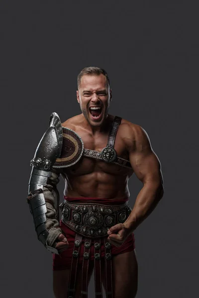 Violent gladiator with naked torso screaming at camera — Stok fotoğraf