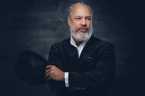 Senior man with hat dressed in black classic suit — Stock Photo, Image