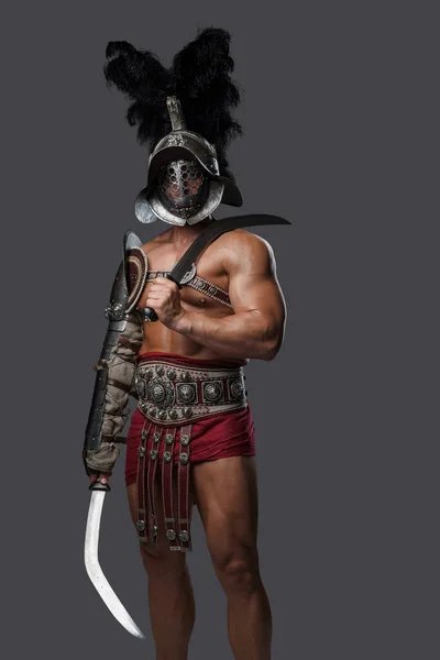 Roman gladiator with plumed helmet holding two swords — Stock Photo, Image