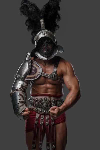 Strong roman gladiator dressed in light armor and plumed helmet — Stock Photo, Image