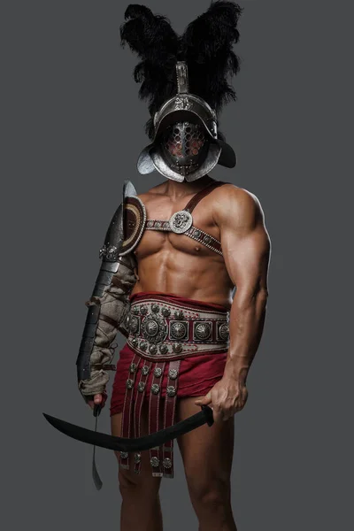 Roman gladiator with plumed helmet holding two swords — Stock Photo, Image