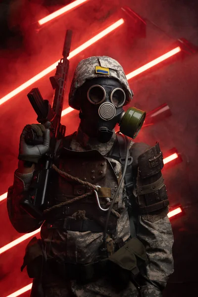 Art of soldier dressed in armor and gas mask against red background with smoke and neon.