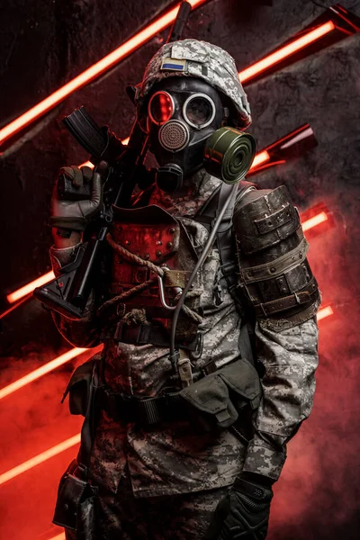 Art of soldier dressed in armor and gas mask against red background with smoke and neon.