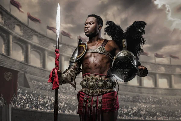 Portrait Victorious Gladiator African Ethnic Holding Plumed Helmet Spear Coliseum — Stok fotoğraf