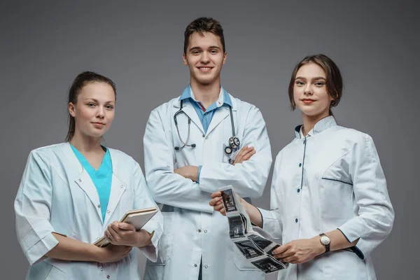 Shot Joyful Team Three Doctors Notebook Ray Shots Grey Background — Stock Photo, Image
