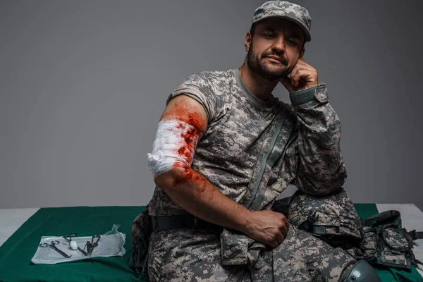 Shot of wounded soldier patient dressed in camouflage uniform looking at camera.