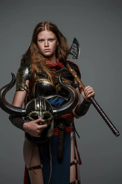 Shot Female Warrior Helmet Axe Dressed Armor Grey Background — стоковое фото