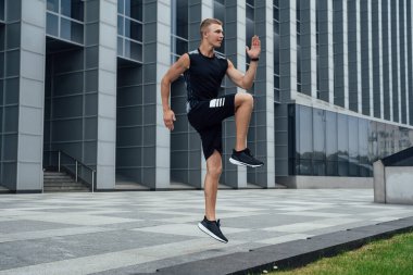 Erkek sporcunun şehirde koşmaya hazırlandığı sahne..