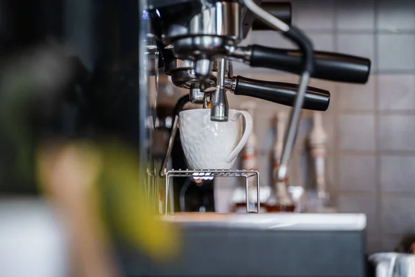 Shot of empty coffee bar and coffee machine with coffee cup in daytime.