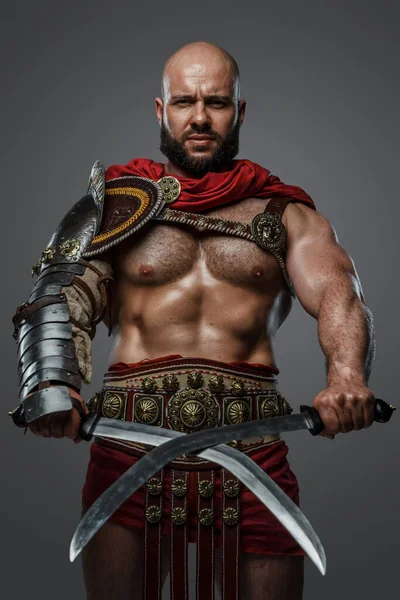 Portrait Ancient Gladiator Bare Torso Posing Dual Swords Grey Background — Stock Photo, Image