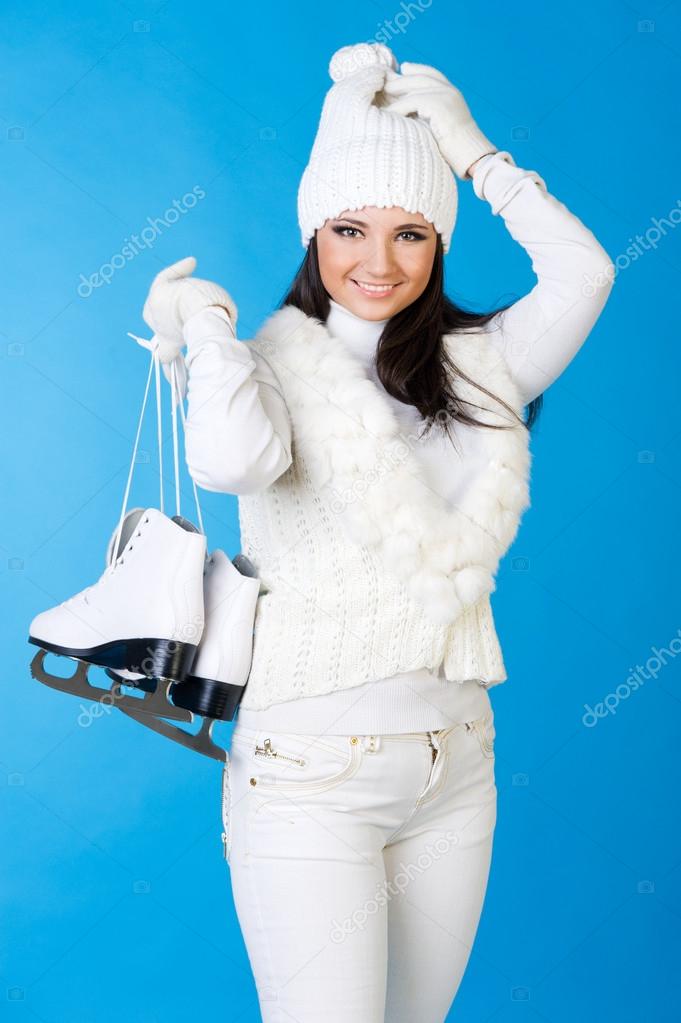 Beautiful woman in winter clothes with skates.